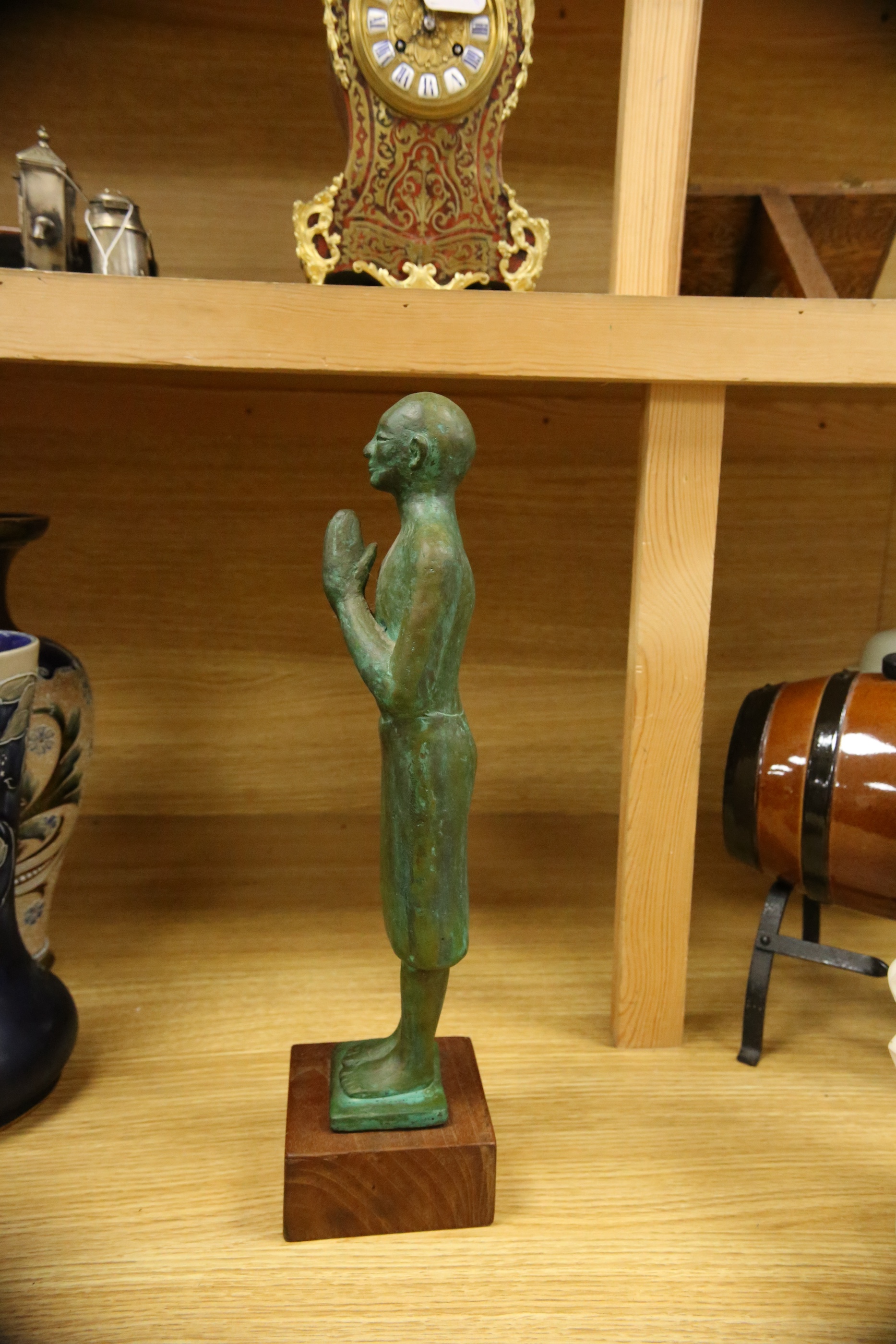 A figural bronze of an Oriental gentleman in prayer, height 42cm including stand. Condition - good